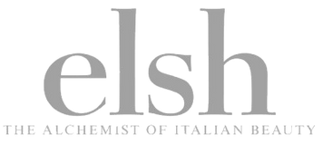 The brand logo for 'elsh' featuring the wordmark in a gray serif typeface with the tagline 'THE ALCHEMIST OF ITALIAN BEAUTY' underneath, set against a solid white background.